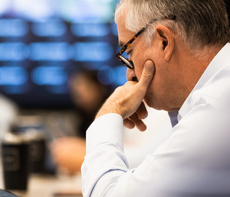 A man in thought with hand on cheek